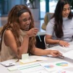 An image of a woman smiling in a work setting.