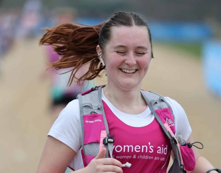 Marathon runner smiling and running