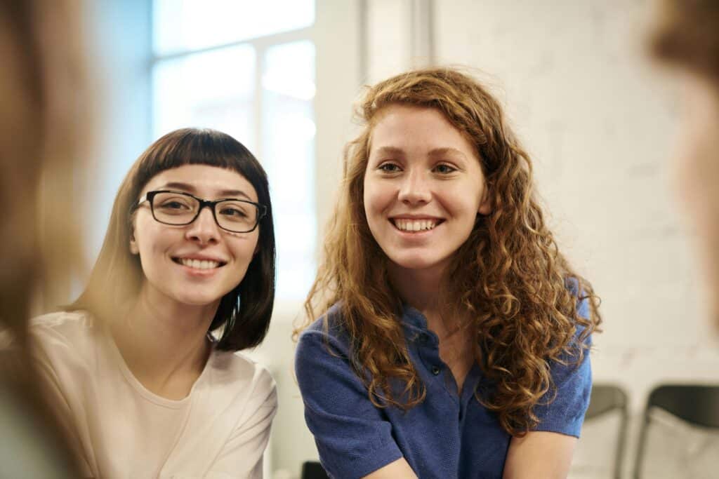 Two young women smiling together