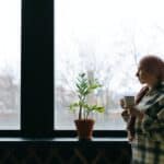 Woman standing by window