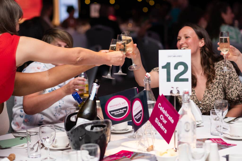 People celebrating at a table holding glasses