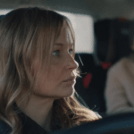 Woman in car with child in the backseat